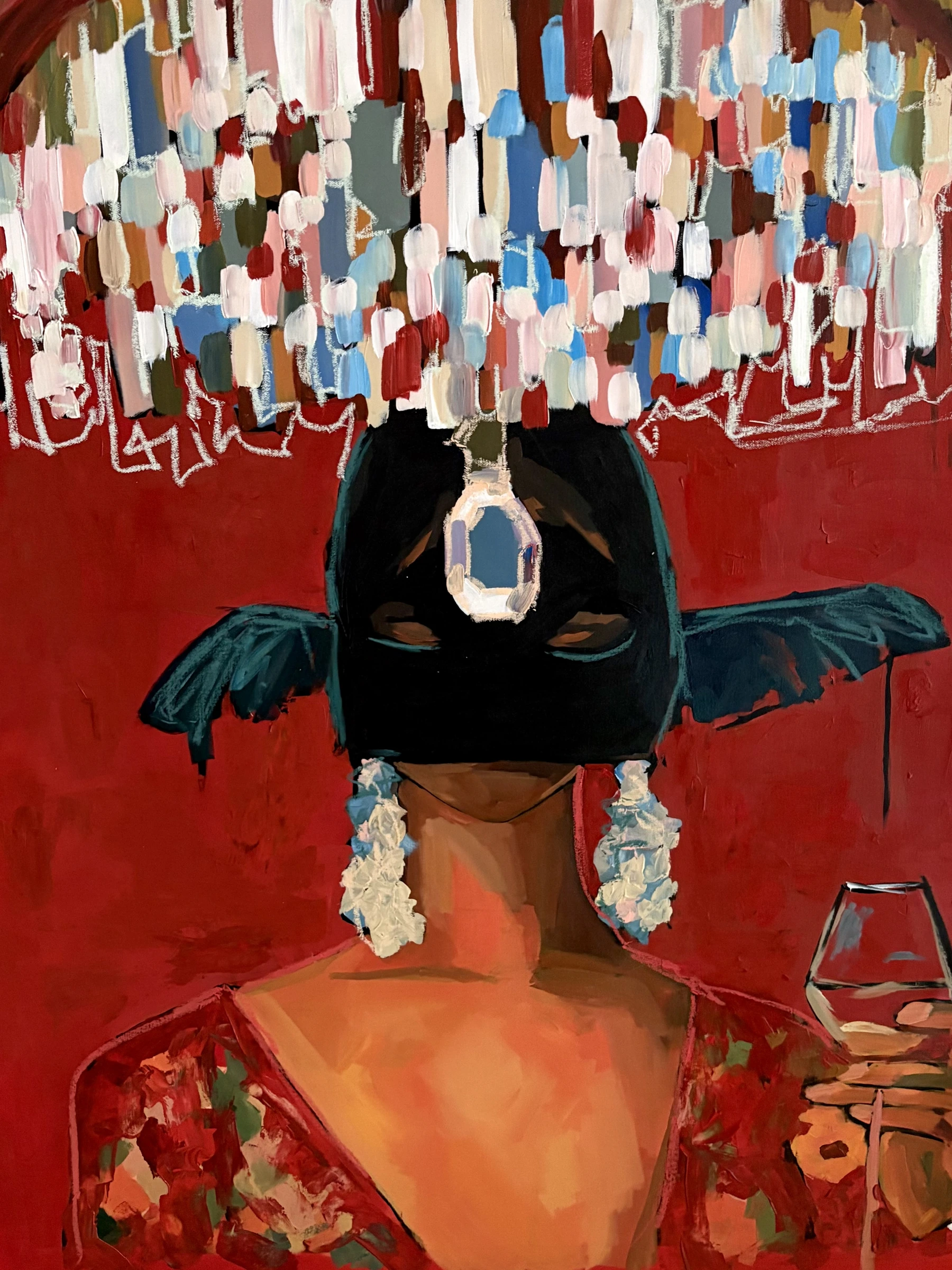 A woman in a dark hat beneath a colourful chandelier, holding a wine glass against a red background
